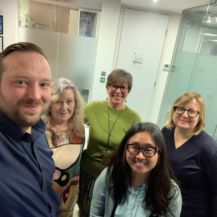 Group of friendly looking caring organisation members.